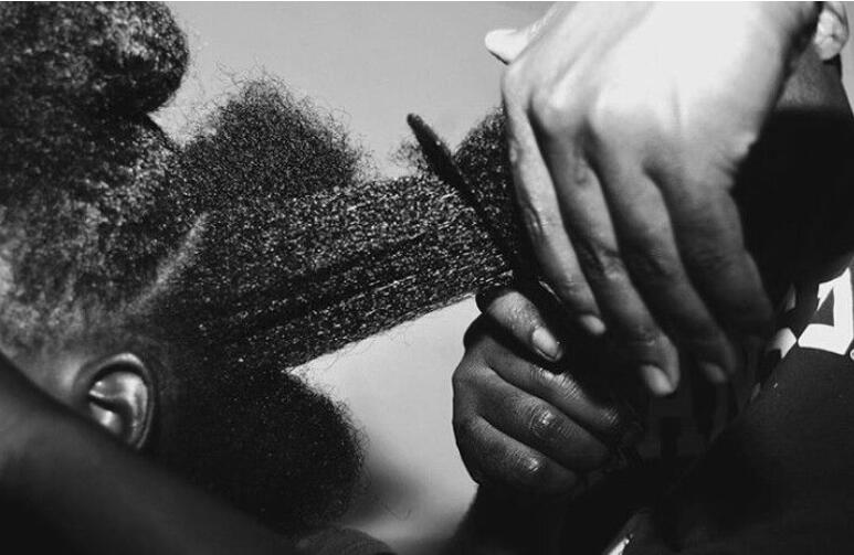 A girl getting her hair done.